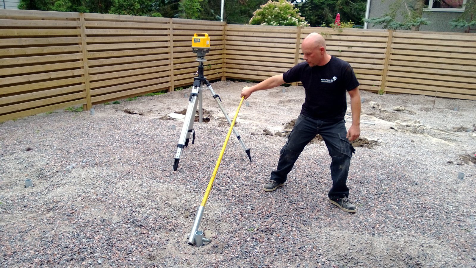 One person installing a HELIX screw pile by hand with a lever bar